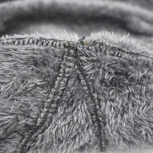 Detailed close-up of thick grey fleece lining and black reinforced stitching for warmth