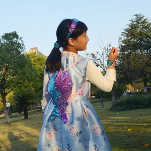Detail view of a sparkling mermaid tail sequin drawstring backpack for girls