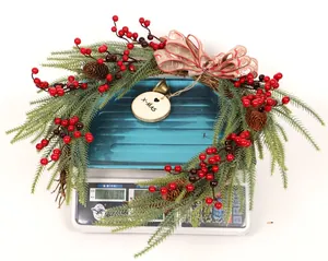 Detailed view of a Christmas wreath weighing 0.430kg with red berries and bow