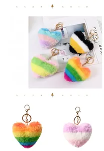 Detail shot of heart-shaped faux fur keychain with striped patterns and gold metal clasp