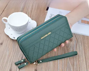 Detail of dark green double zipper wallet with luxury plaid stitching and gold hardware