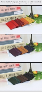Detailed view of genuine leather mini zipper coin purses in various vibrant colors