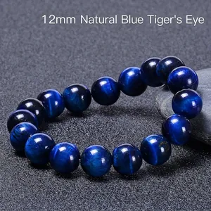 Macro shot of 12mm Natural Blue Tiger Eye stone beads showing silky cat eye effect