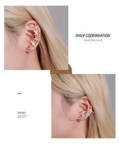 Detail of crystal butterfly floral ear cuffs in gold finish with sparkling rhinestones