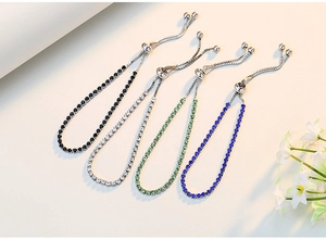 Detail of four tennis bracelets with colorful zircons and adjustable sliding clasps