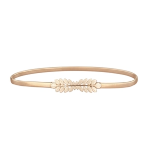 Detail of elegant gold leaf buckle on elastic metal waist belt for women's dresses
