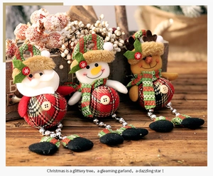 Close-up of Santa, Snowman and Reindeer fabric ornaments with silver bells and plaid details