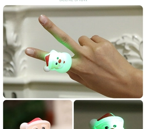 Detail of LED Santa Claus ring with green glowing light and soft elastic band