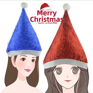 Detail view of red and blue Christmas hats with glitter fabric and white fluffy pom-poms