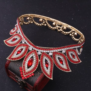 Detailed shot of Baroque crown with red and clear rhinestones on vintage wood