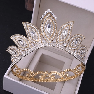 Macro view of a gold baroque bridal crown with sparkling rhinestones in a white gift box