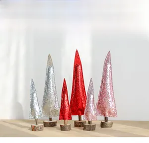 Detailed view of mini sequin Christmas trees in pink red and silver with wood bases