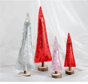 Macro detail of glittered mini Christmas trees with natural wood bases in silver and red
