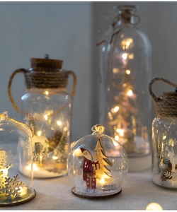 Close-up of Nordic Christmas glass lamps with wooden Santa, elk scenes and warm LED lights