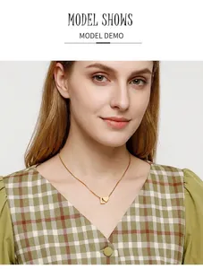 Nahaufnahme eines goldenen Herzanhängers mit Buchstabe L an einer feinen Kette
