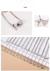 Macro detail of silver heart charm necklace featuring uppercase alphabet A-Z pendant set