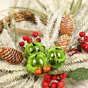 Christmas wreath with green star bells, frosted pine cones and red berries decor