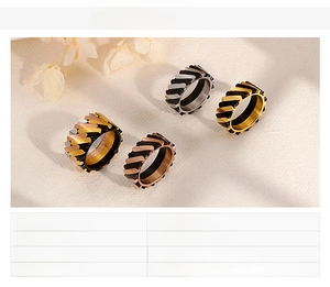 Close-up of tiered stainless steel rings in silver, gold, rose gold and black colors
