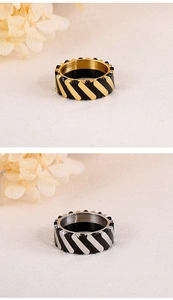 Detail view of wide titanium steel rings featuring dual-tone rhombus patterns in gold and silver