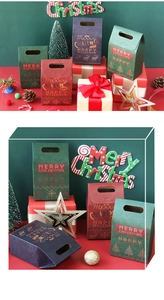 Close-up of assorted festive Christmas gift bags with Merry Christmas gold lettering