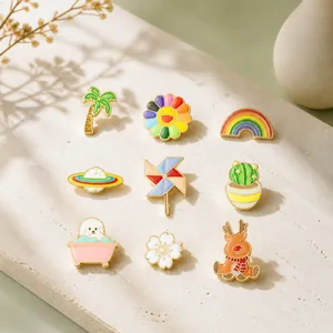 Macro view of 9-piece set of colorful enamel cartoon pins featuring rainbow and motifs