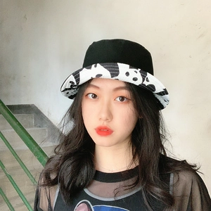 Reversible panda style bucket hat for women featuring black and white spotted patterns
