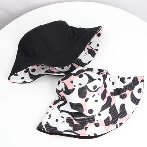 Detailed view of reversible panda bucket hat with cute black and pink cartoon print pattern