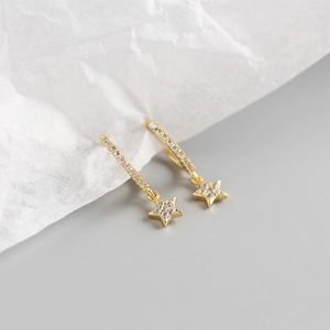 Macro shot of S925 sterling silver gold star hoop earrings with sparkling zircon stones