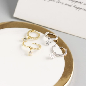Detailed close-up of gold and silver S925 star hoop earrings with sparkling cubic zirconia
