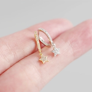 Detailed view of S925 sterling silver star drop earrings in gold and silver finishes