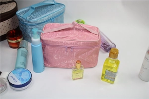 Pink and blue large makeup cases with top handles and textured letter patterns