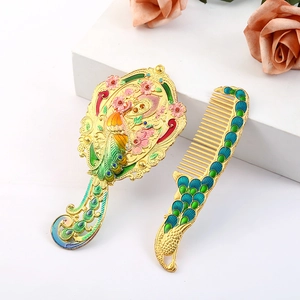 Vintage metal hand mirror and comb set with peacock floral relief and colorful enamel