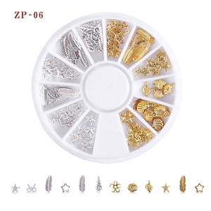 Macro view of gold and silver nail art studs including shells and stars in a 12-slot case