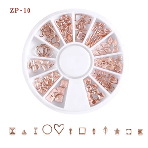Macro shot of rose gold alloy nail art studs in 12-grid storage box for manicure design