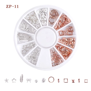 Detail of mixed metal nail art studs featuring stars and shells in a 12-grid rotary box