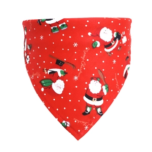 Detail of red cotton Christmas dog bandana with Santa Claus print and Merry Christmas text