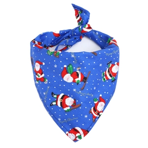 Detailed view of blue Christmas dog bandana with skiing Santa Claus and Merry Christmas print