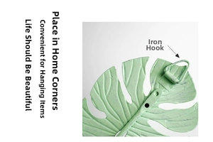 Detail of mint green monstera leaf metal wall hook featuring a sturdy iron back hanger