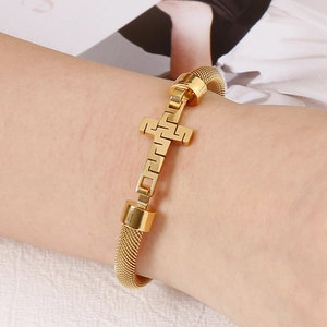 Titanium steel mesh bracelet with Greek key pattern cross pendant worn on wrist