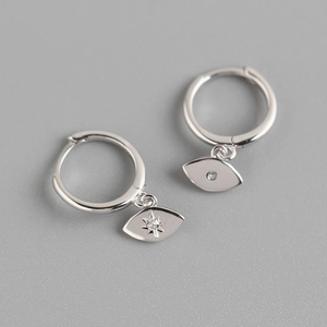 Detailed macro view of S925 sterling silver asymmetrical eye and starburst hoop earrings