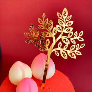Golden mirror acrylic money tree cake topper featuring dollar signs on a festive cake