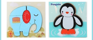 Detail of wooden animal puzzles showing blue elephant and penguin cognitive boards