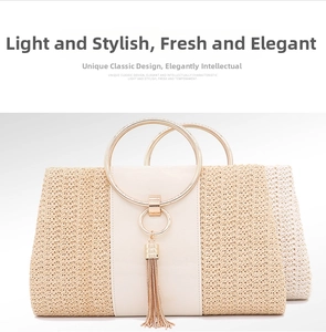 Close-up of beige straw woven evening clutch bag with metal handles and gold tassel