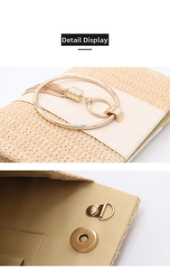 Detail of straw woven clutch showing gold ring hardware and magnetic closure