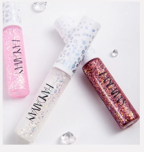 Detailed macro shot of shimmering glitter eyeliner tubes in pink and bronze shades