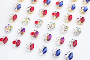 Macro detail of paw-shaped nail art charms with K9 rhinestones and colorful crystals