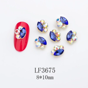 Macro detail of 8x10mm marquise crystal nail charms with metal setting and rhinestones