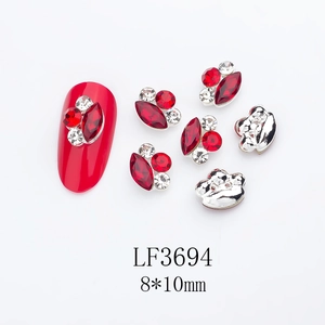 Macro view of crystal nail charms with red rhinestones and silver metal base 8x10mm