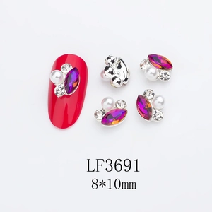 Detailed view of 8x10mm horse eye nail art charm with purple stone and pearls on red nail