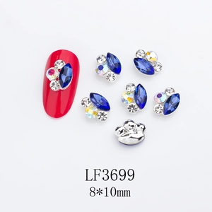 Macro shot of 8x10mm alloy nail art jewel with marquise blue stone and tiny crystals